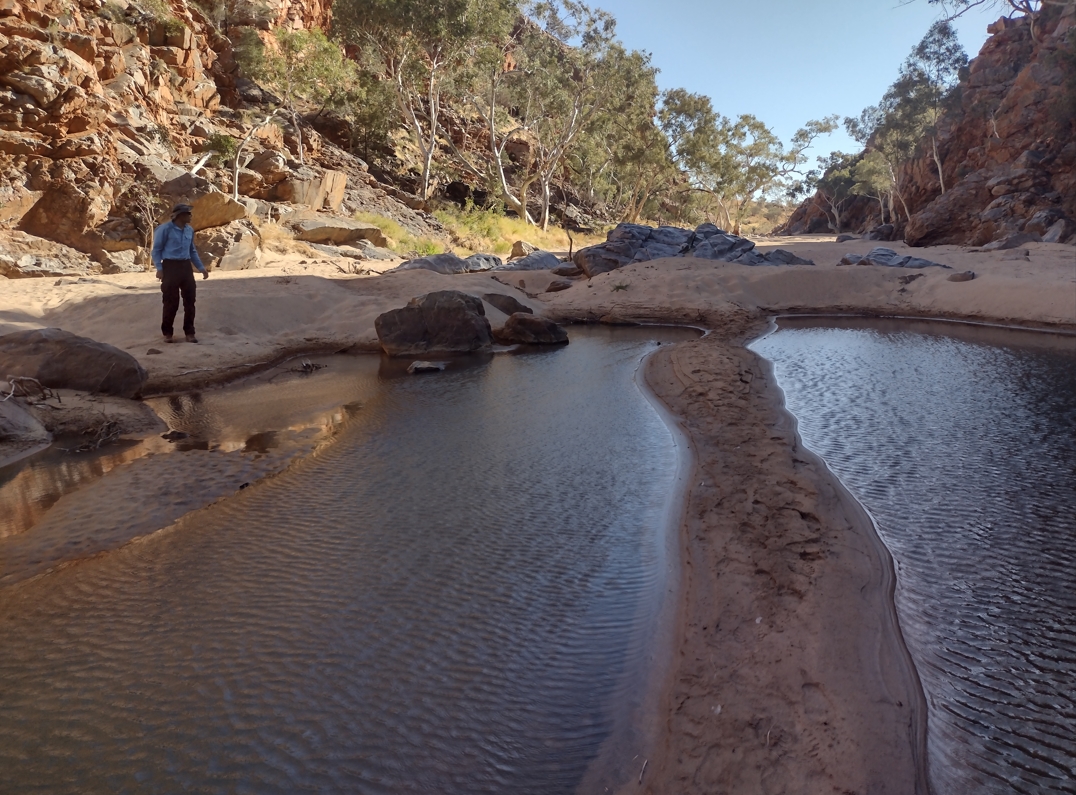 Fraser scouting the attractive sandy waterhole in Stuart's Pass